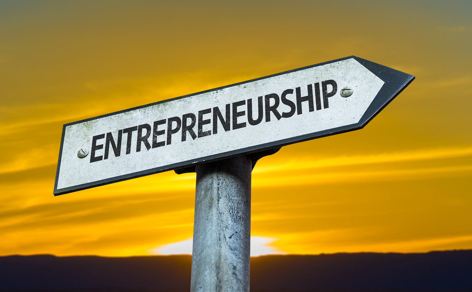 Entrepreneurship sign with a sunset background